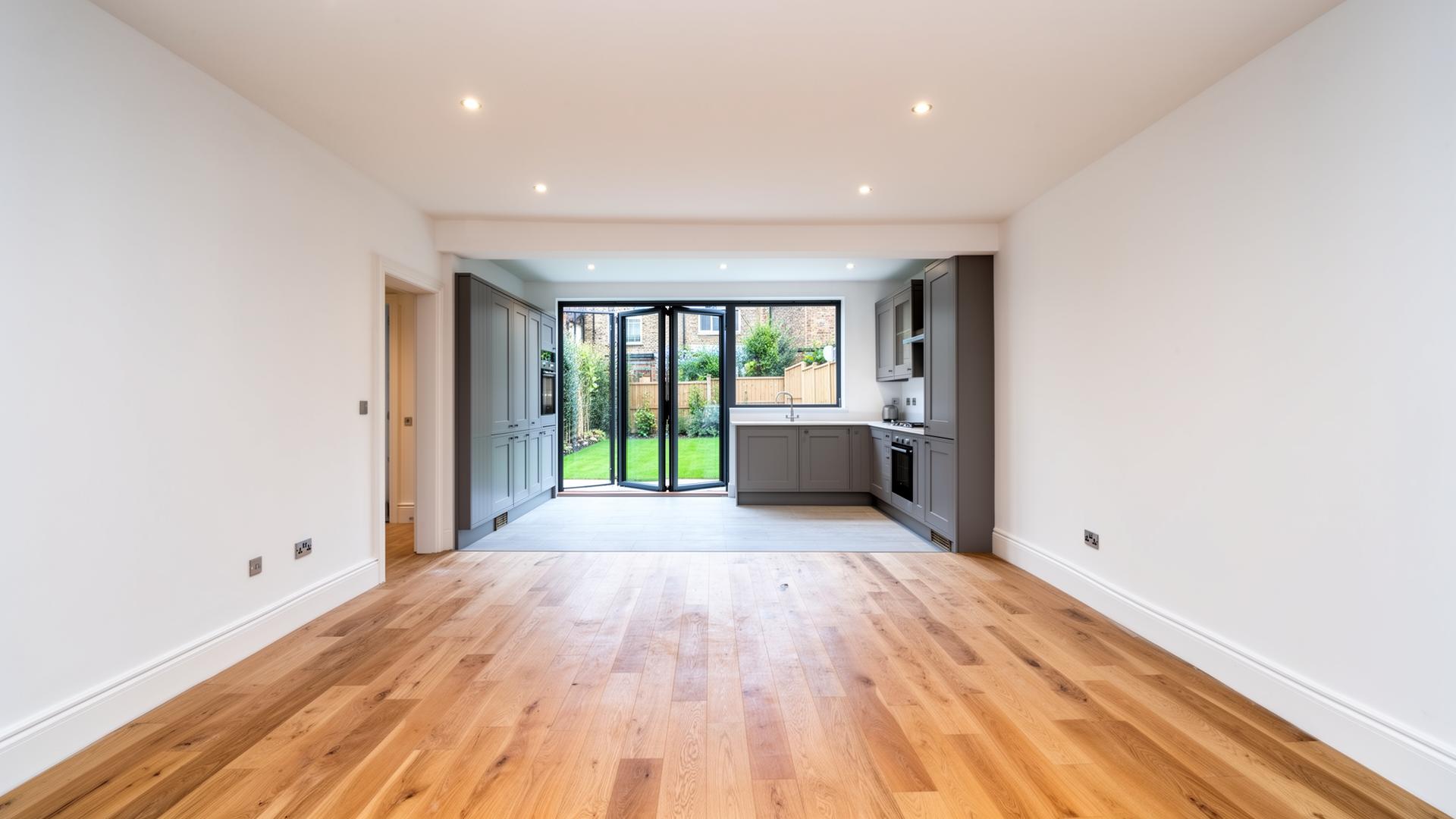 Fully renovated open-plan living space with new oak flooring and bi-fold doors